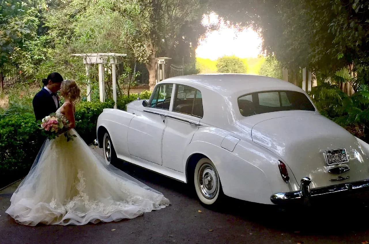 White 1960 Rolls-Royce Silver Cloud II exterior for wedding car rental in Tarzana, CA White 1960 Rolls-Royce Silver Cloud II exterior for wedding car rental in Tarzana, CA