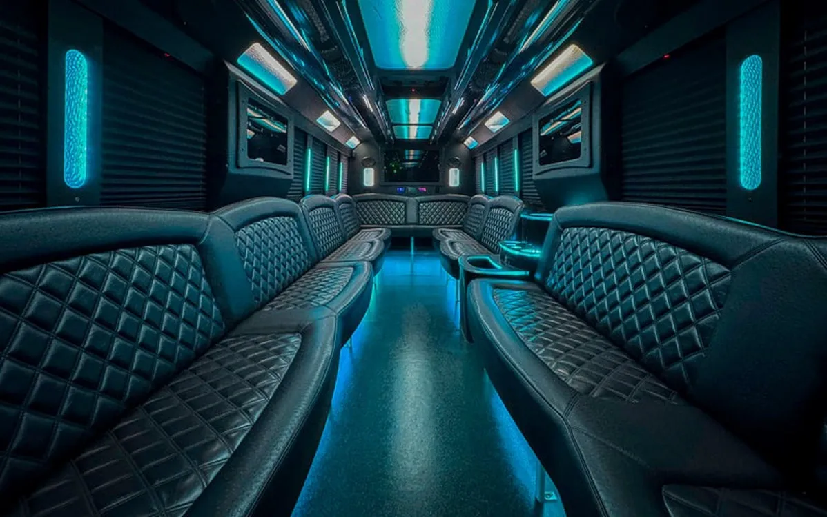 Ford F-550 Party Bus interior with perimeter lounge seating, window shades and LED accent lighting for party bus rental