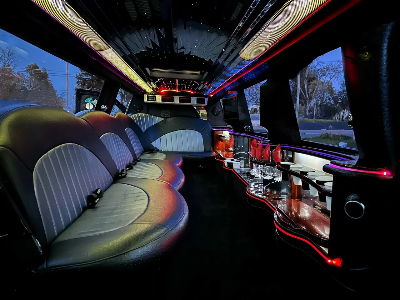 Cadillac Escalade Limousine interior with LED accent lighting, LED ceiling lighting and bar area for limo rental
