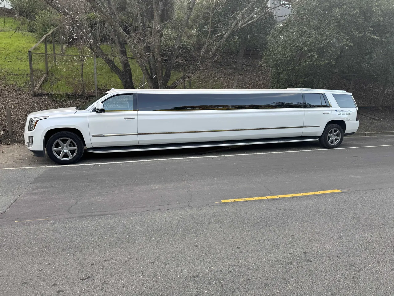 White Cadillac Escalade Limousine exterior with tinted windows for party bus rental in El Cerrito, CA
