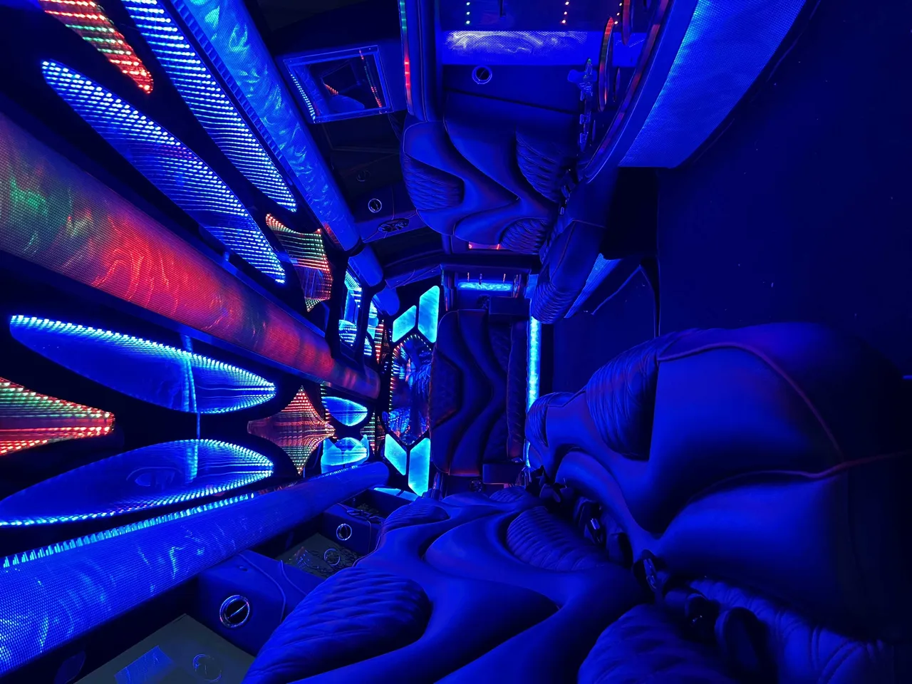 Cadillac Escalade Limousine interior with LED accent lighting and LED ceiling lighting for party bus rental in El Cerrito, CA