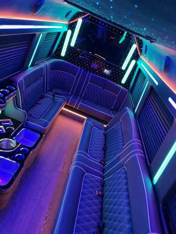 Cadillac Escalade Limousine interior with sofa-style seating, window shades and LED accent lighting for limo rental in Montville, NJ