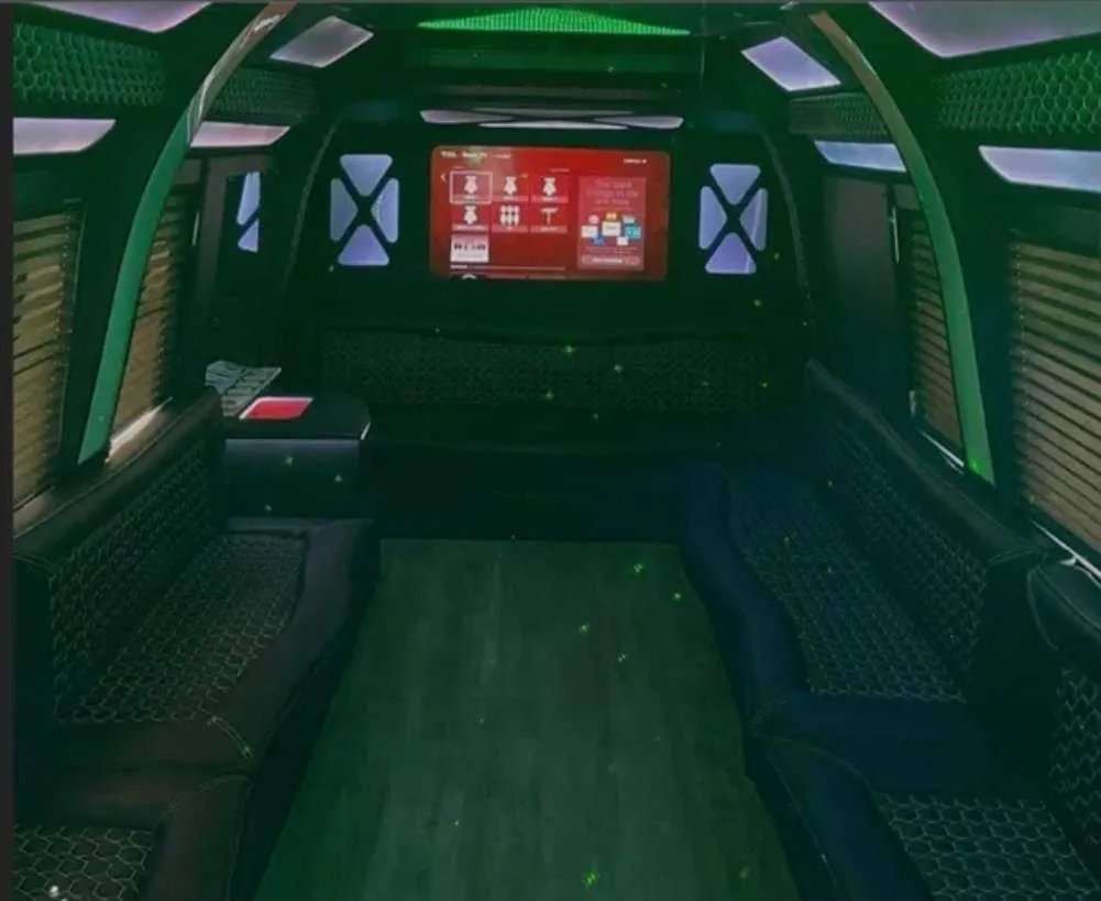 D-Town Bus interior with perimeter lounge seating, window shades and LED accent lighting for party bus rental