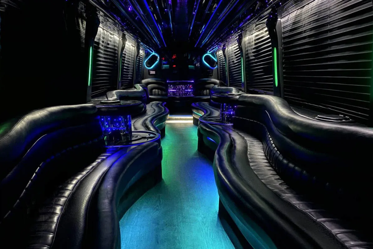 Entertainment Coach interior with perimeter lounge seating, window shades and LED accent lighting for party bus rental in North Attleboro, MA Entertainment Coach interior with perimeter lounge seating, window shades and LED accent lighting for party bus rental in North Attleboro, MA