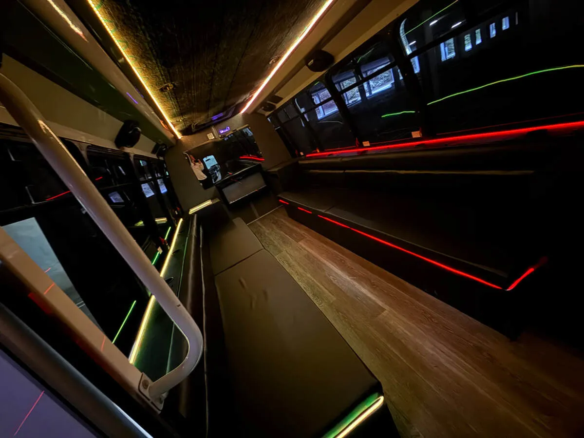 Ford E-450 Series Party Bus interior with perimeter lounge seating, LED accent lighting and LED ceiling lighting, photo 2 for party bus rental in North Attleboro, MA