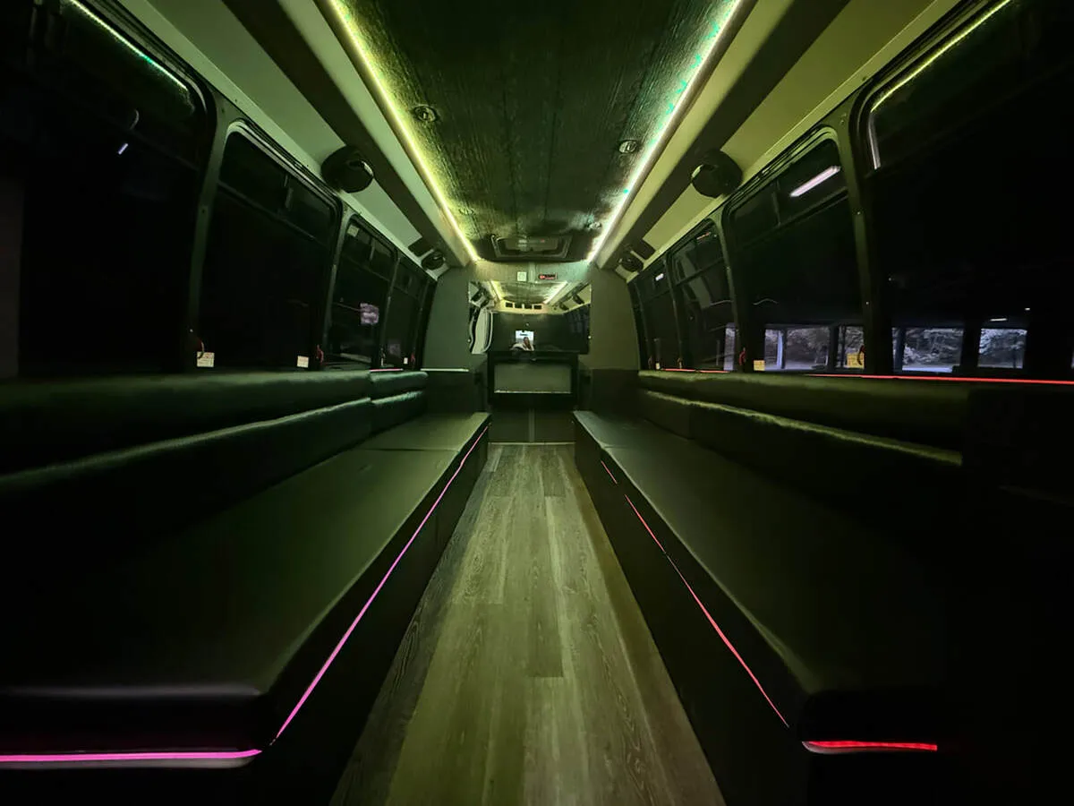 Ford E-450 Series Party Bus interior with perimeter lounge seating, LED accent lighting and LED ceiling lighting, photo 3 for party bus rental in North Attleboro, MA