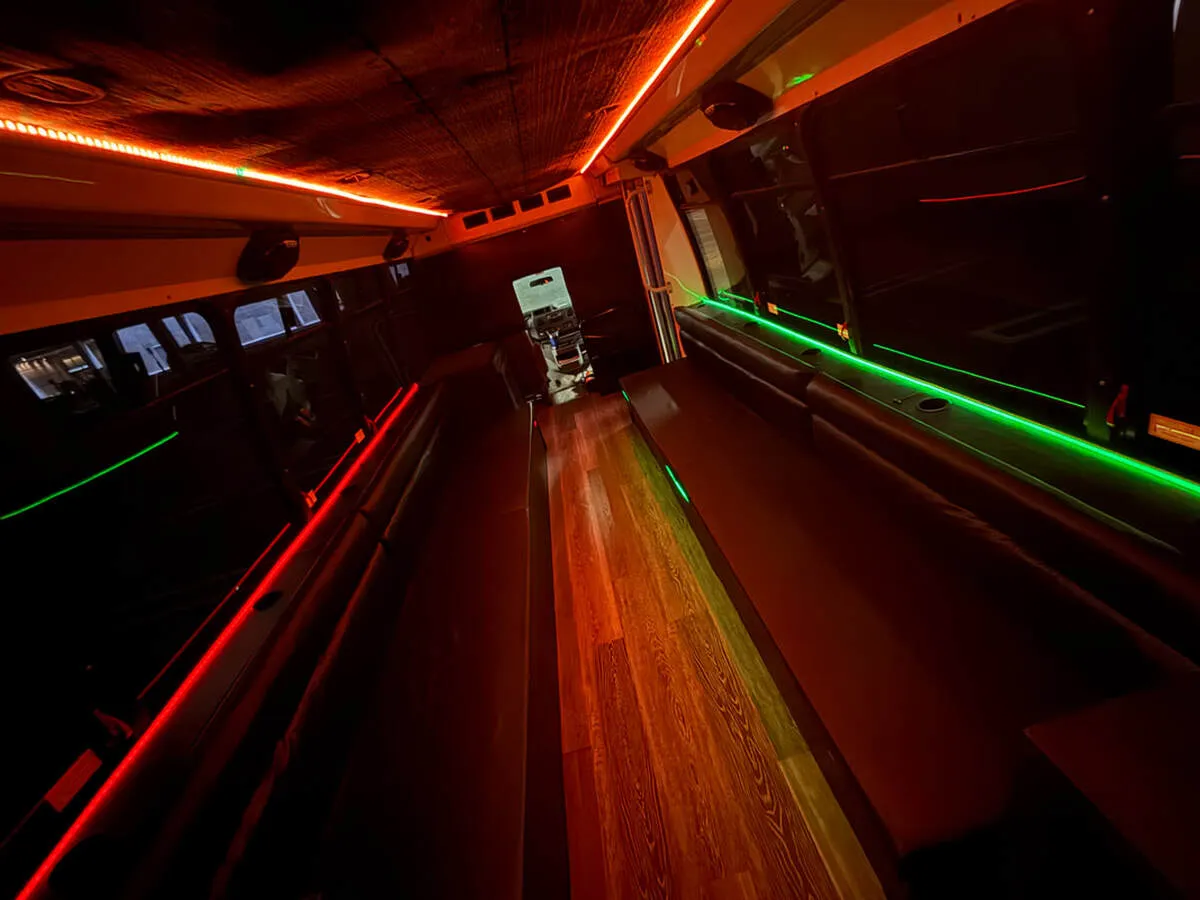 Ford E-450 Series Party Bus interior with perimeter lounge seating, LED accent lighting and LED ceiling lighting, photo 4 for party bus rental in North Attleboro, MA