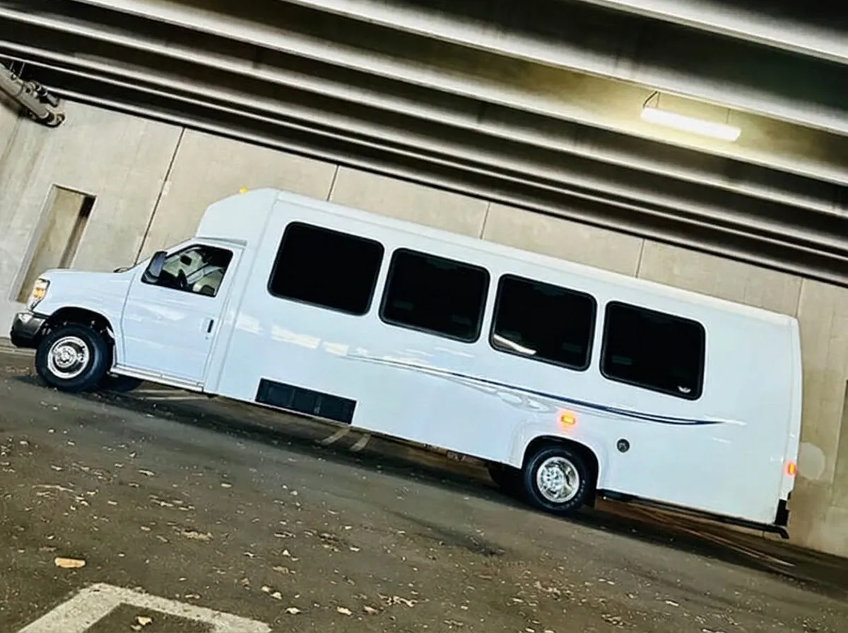 White-painted Ford E-450 Series Party Bus ready for booking