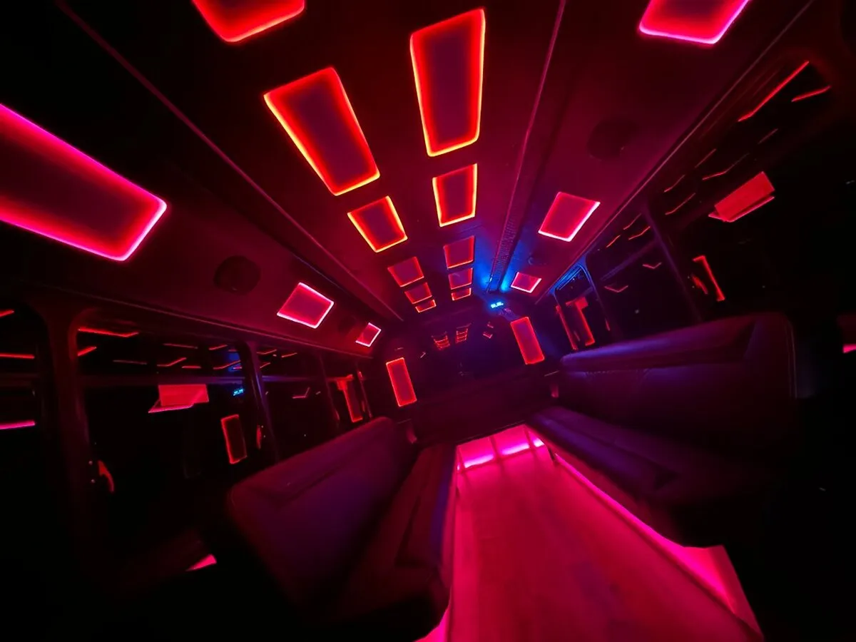 Ford E-450 Series Party Bus interior with LED accent lighting and LED ceiling lighting for party bus rental in North Attleboro, MA