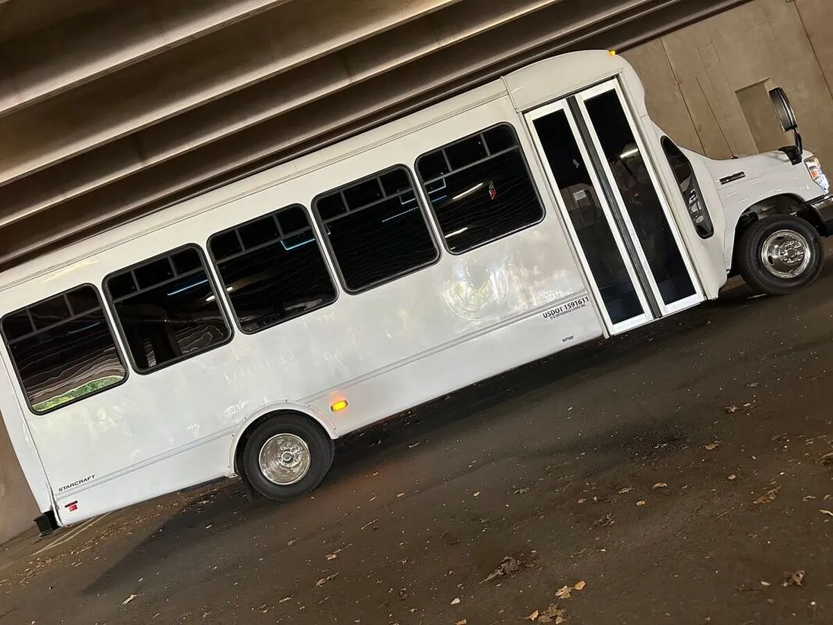 White Ford E-450 Series Party Bus exterior with tinted windows for party bus rental in North Attleboro, MA
