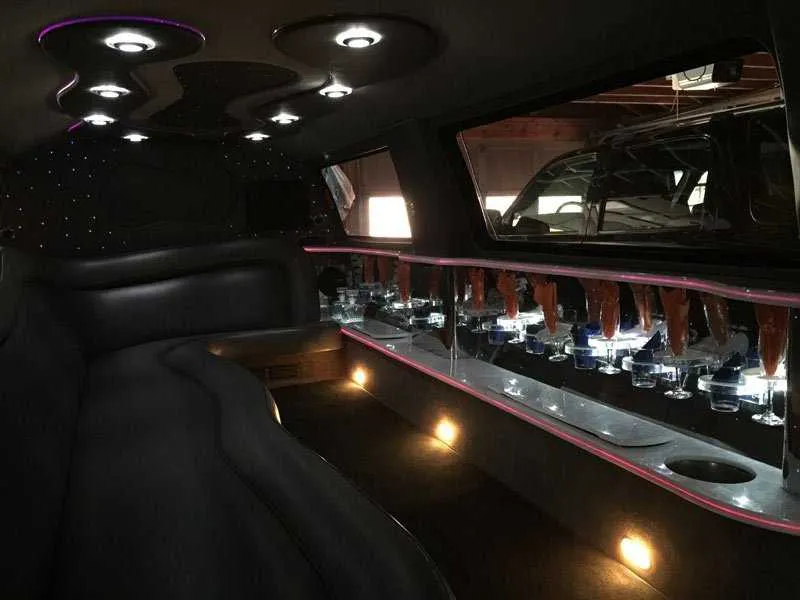 Ford Excursion Limousine interior with LED accent lighting, starlight or fiber-optic ceiling and bar area for limo rental in New Castle, DE