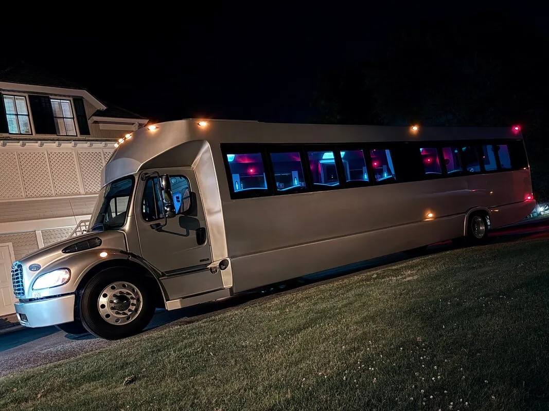 Silver Freightliner Party Bus exterior with tinted windows, photo 6 for party bus rental in North Attleboro, MA