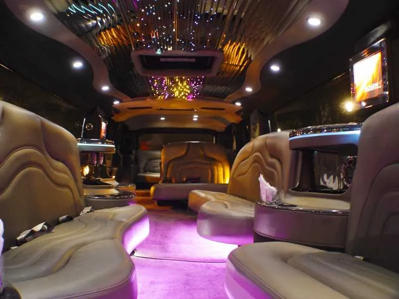 Hummer Limousine interior with LED accent lighting, starlight or fiber-optic ceiling and TV screens for limo rental