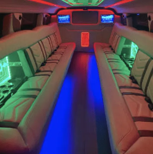 Hummer Limousine, inside view, perimeter lounge seating, LED accent lighting and TV screens