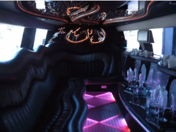 Hummer Limousine, inside view, lit dance floor and bar area