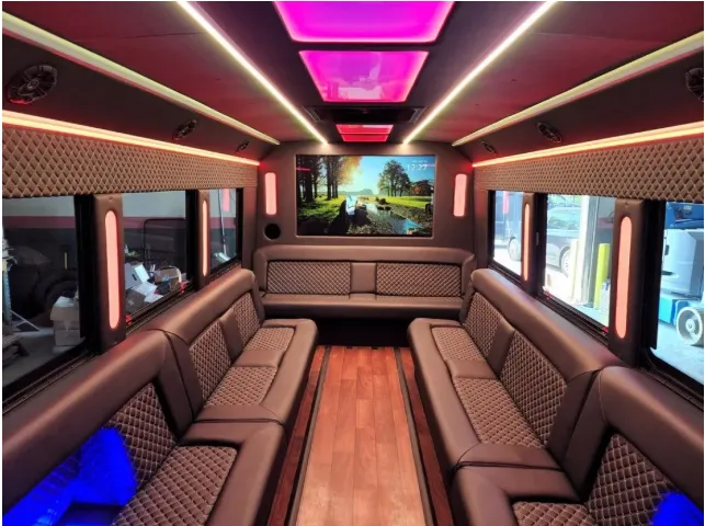 Limousine Bus interior with perimeter lounge seating, LED accent lighting and LED ceiling lighting, photo 2 for party bus rental in Kenner, LA