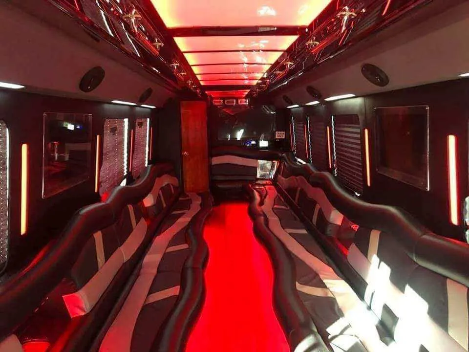 Limousine Bus interior with perimeter lounge seating, LED accent lighting and LED ceiling lighting for party bus rental in Memphis, TN
