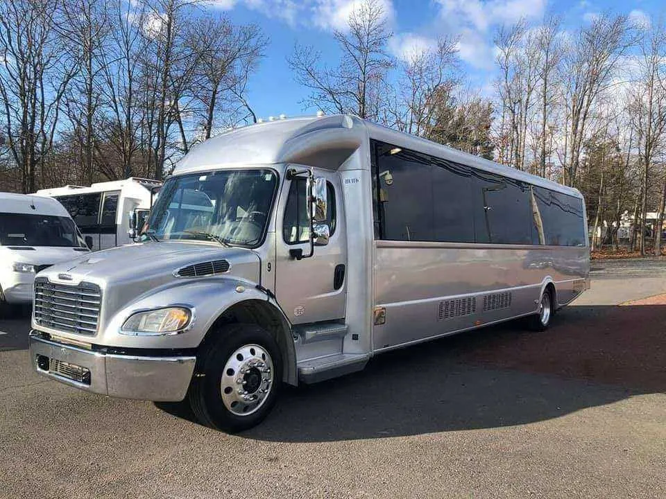 Silver Limousine Bus exterior with tinted windows for party bus rental in Memphis, TN