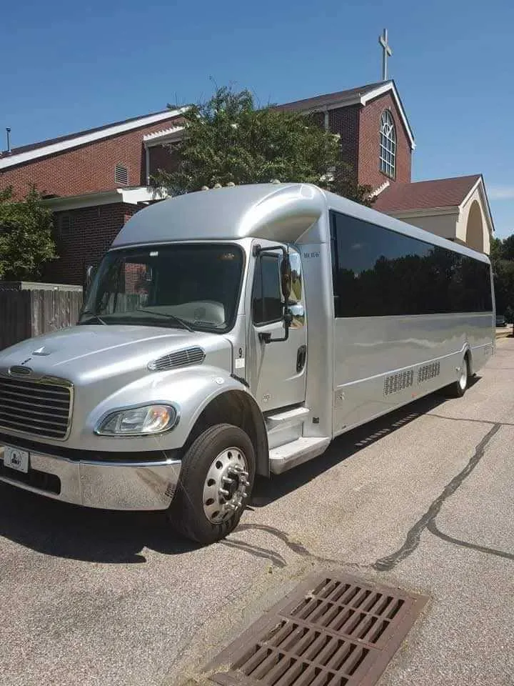 Silver Limousine Bus exterior with tinted windows, photo 5 for party bus rental in Memphis, TN