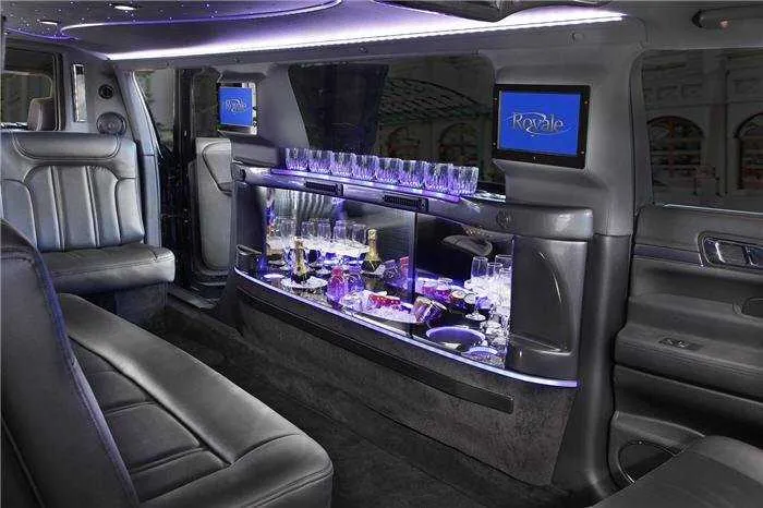 Lincoln MKT Limousine interior with LED accent lighting, bar area and glassware holders for wedding car rental in Woodland, CA