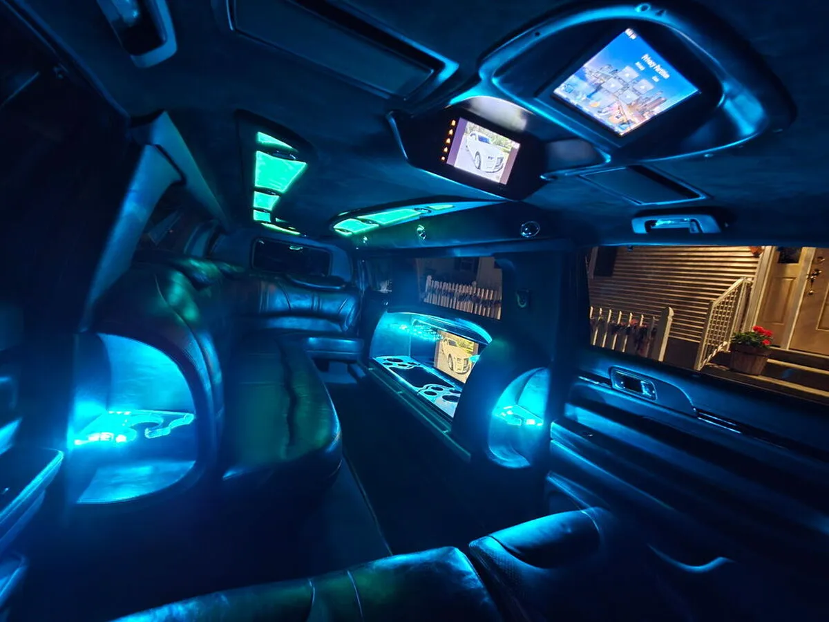 Lincoln MKT Limousine interior with LED accent lighting and TV screens for limo rental in Huerfano County, CO
