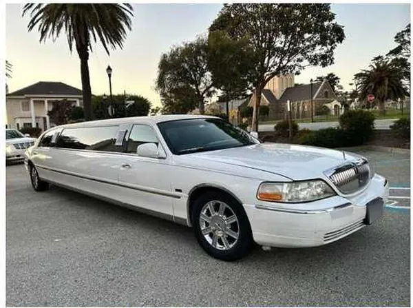 White-painted Lincoln Town Car Limousine ready for booking