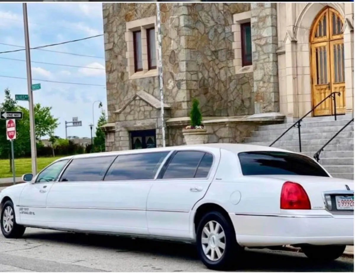 White Lincoln Town Car Limousine with tinted windows for wedding car rental in North Attleboro, MA