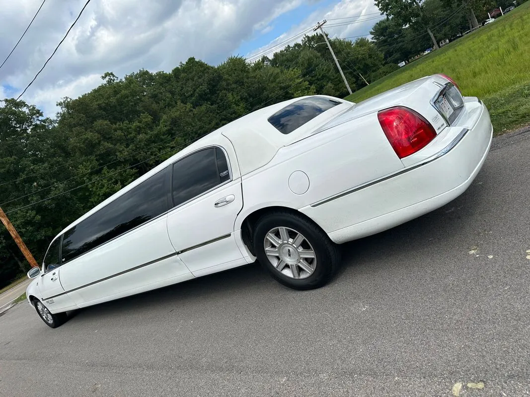 White Lincoln Town Car Limousine exterior with tinted windows, photo 5 for limo rental