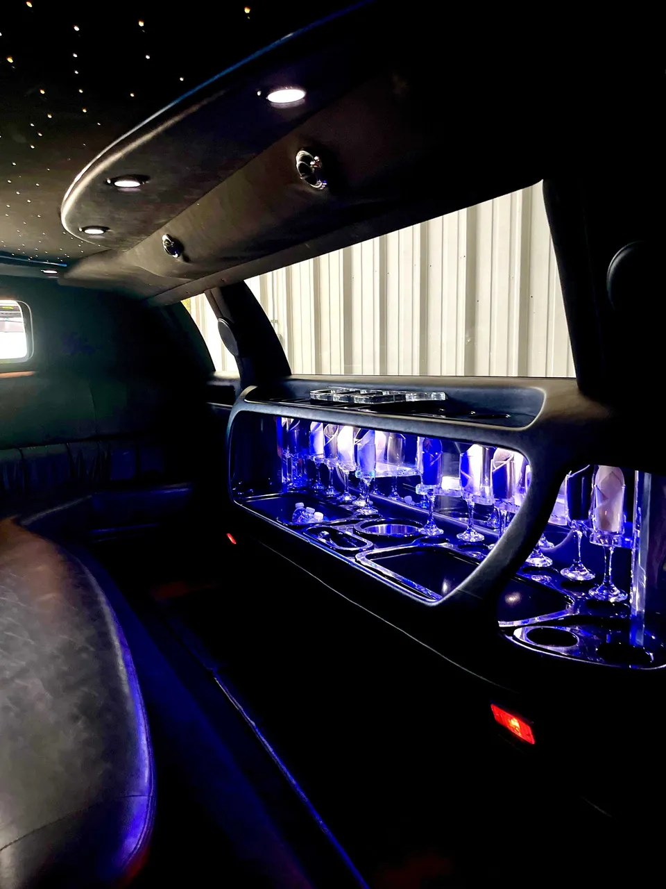 Lincoln Town Car Limousine interior with LED accent lighting, starlight or fiber-optic ceiling and glassware holders for limo rental in Citrus Heights, CA
