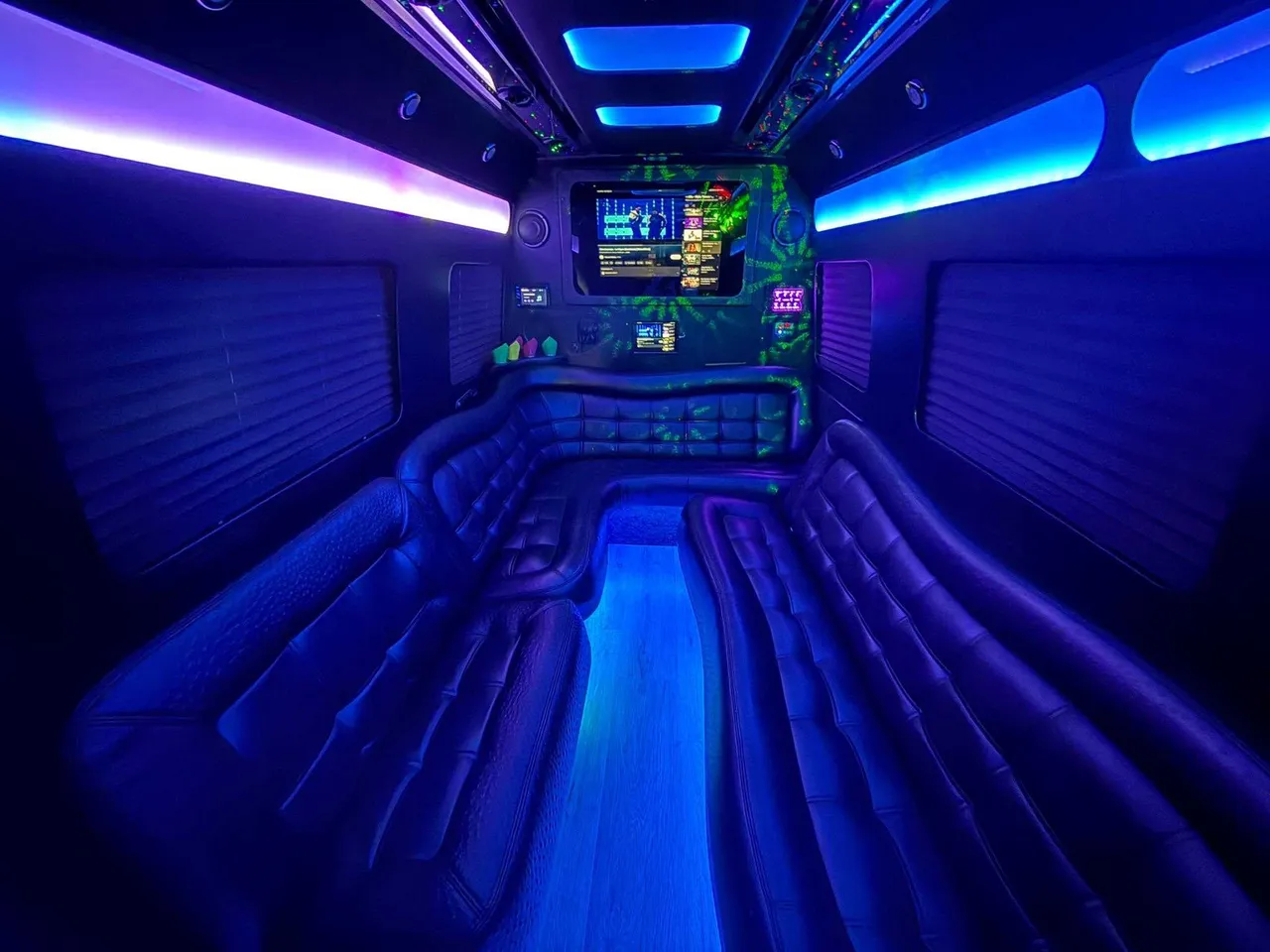Mercedes Limo Sprinter interior with perimeter lounge seating, window shades and LED accent lighting for party bus rental in Luzerne County, PA