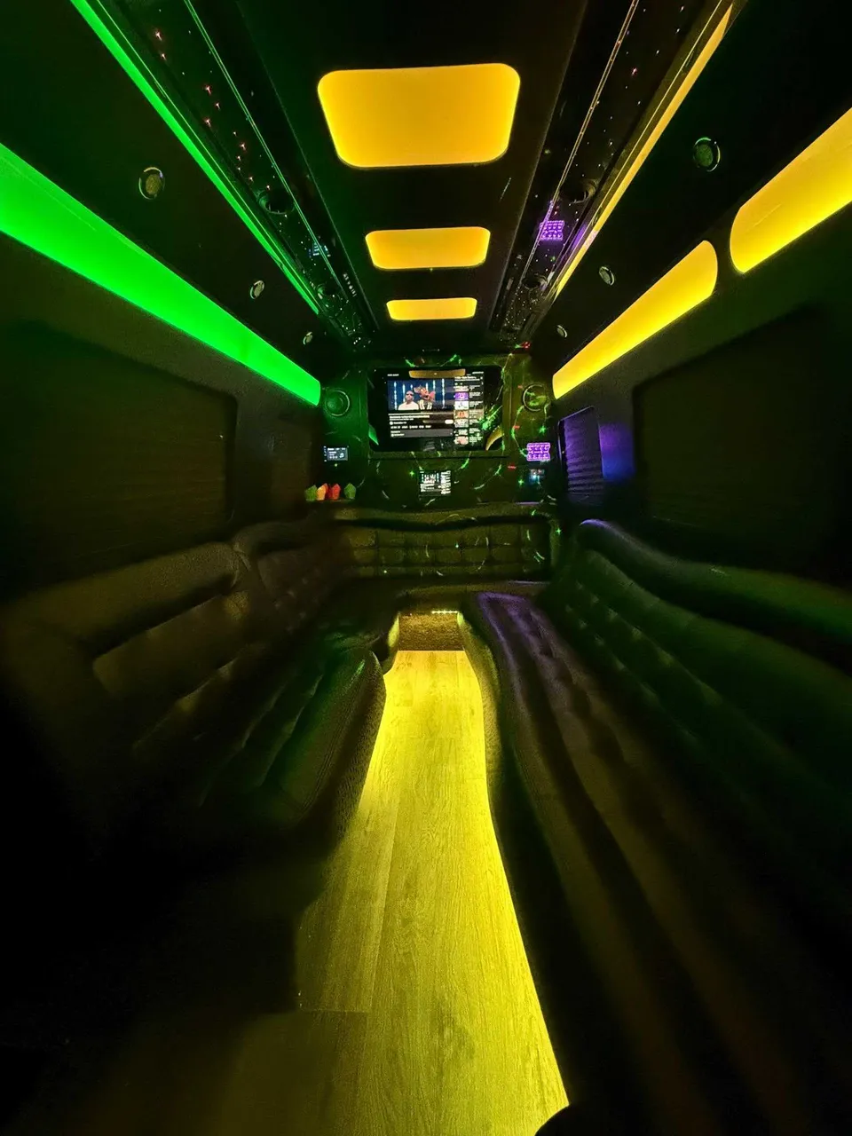 Mercedes Limo Sprinter interior with perimeter lounge seating, LED accent lighting and LED ceiling lighting for party bus rental in Luzerne County, PA