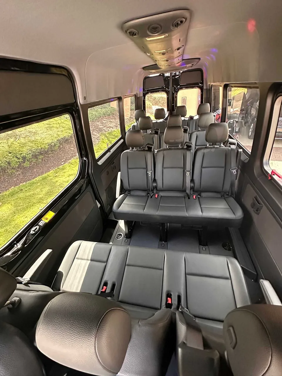 Mercedes-Benz Limousine Sprinter interior with passenger seat belts for party bus rental in West Palm Beach, FL