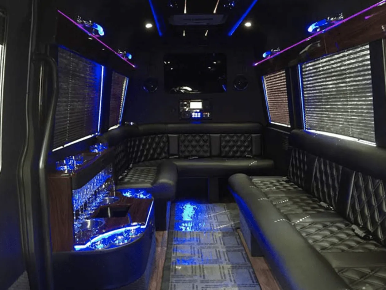 Mercedes Limo Sprinter interior with perimeter lounge seating, window shades and LED accent lighting for party bus rental in Laramie County, WY