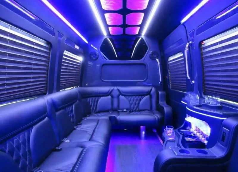 Mercedes Limo Sprinter interior with perimeter lounge seating, window shades and LED accent lighting for party bus rental in Richmond, CA