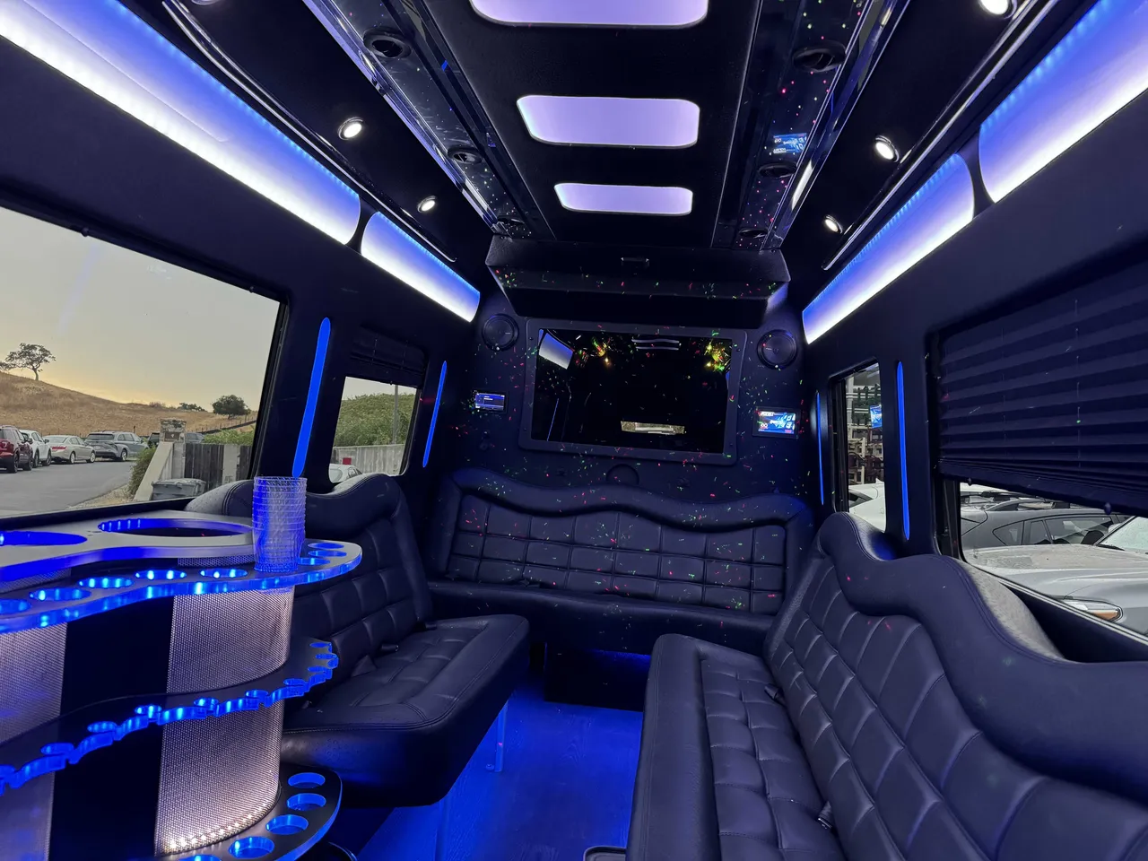 Mercedes Party Bus interior with perimeter lounge seating, window shades and LED accent lighting, photo 5 for party bus rental in Birds Landing, CA