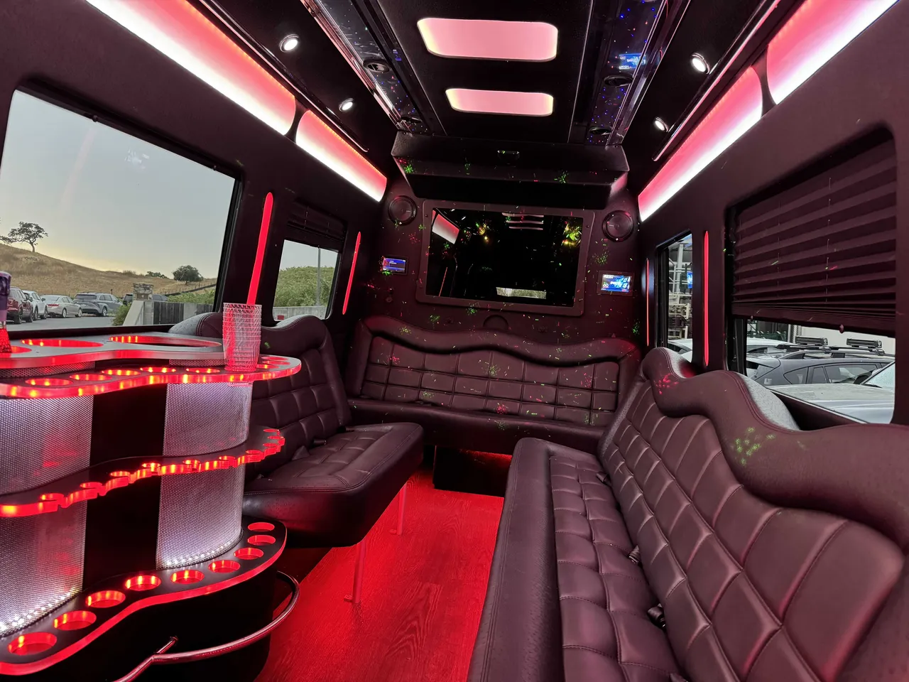 Mercedes Party Bus interior with perimeter lounge seating, window shades and LED accent lighting, photo 6 for party bus rental in Birds Landing, CA