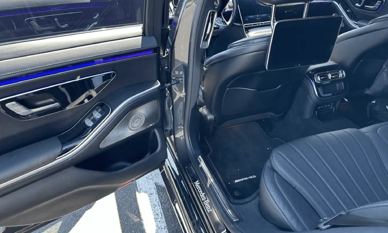 Mercedes-Benz S-Class interior with LED accent lighting and rear-seat entertainment screens for wedding car rental