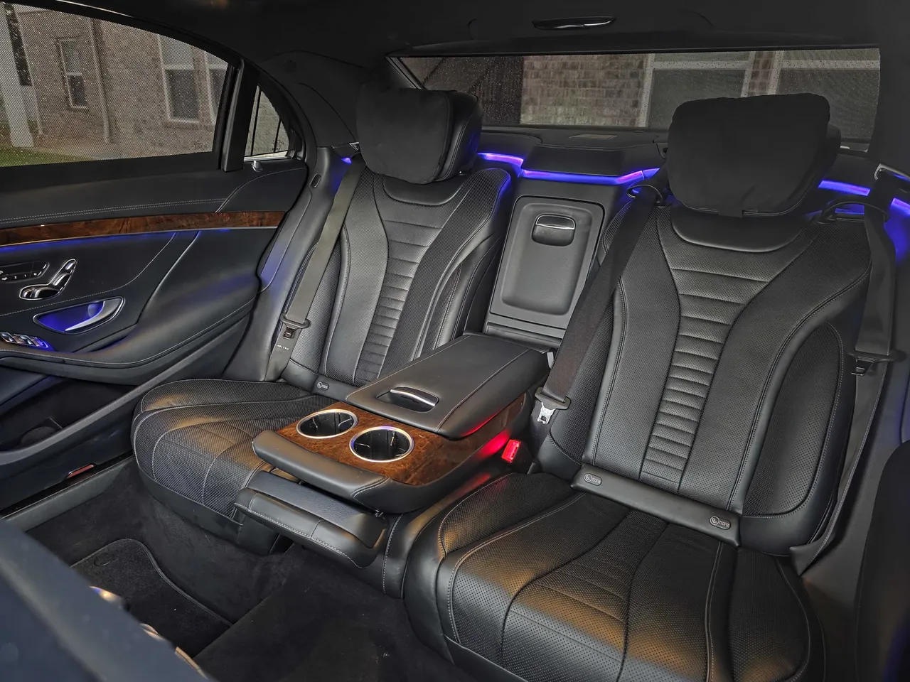 Mercedes-Benz S550 'Duchess' interior with cup holders and LED accent lighting for wedding car rental in Freeport, FL