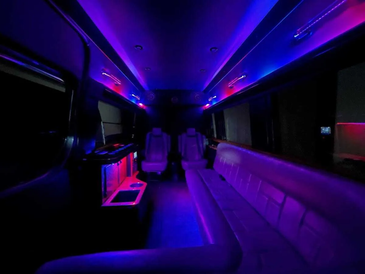 Mercedes Sprinter Limo interior with sofa-style seating, captain's chairs and LED accent lighting, photo 3 for party bus rental in Columbus County, NC