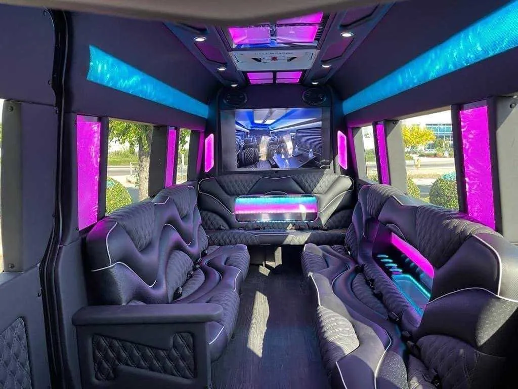 Mercedes Sprinter Limo interior with sofa-style seating, LED accent lighting and LED ceiling lighting for party bus rental in Long Barn, CA