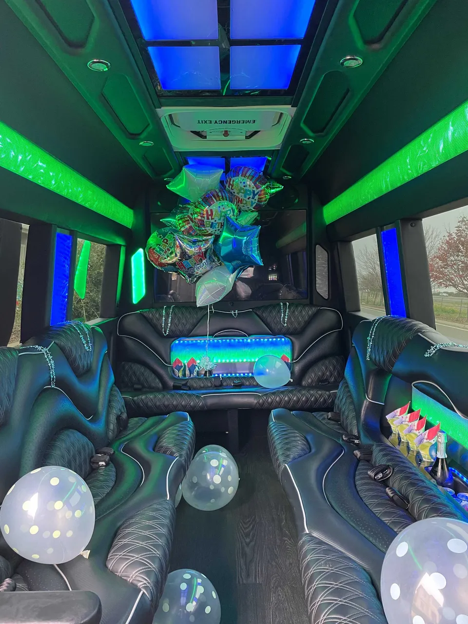 Mercedes Sprinter Limo interior with perimeter lounge seating, LED accent lighting and LED ceiling lighting for party bus rental in Long Barn, CA