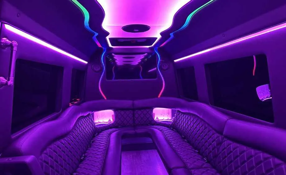Mercedes Sprinter Limo interior with perimeter lounge seating and LED accent lighting for party bus rental in Birds Landing, CA