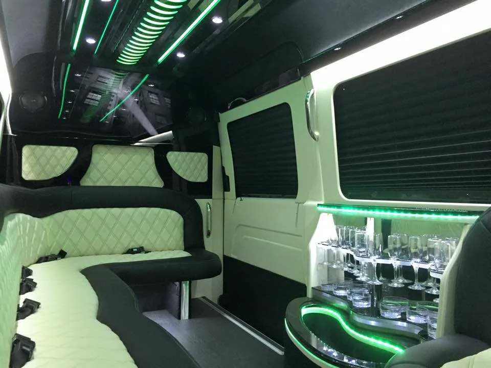 Mercedes-Benz Sprinter Limousine interior with perimeter lounge seating, sofa-style seating and window shades, photo 2 for party bus rental in Plainville, MA