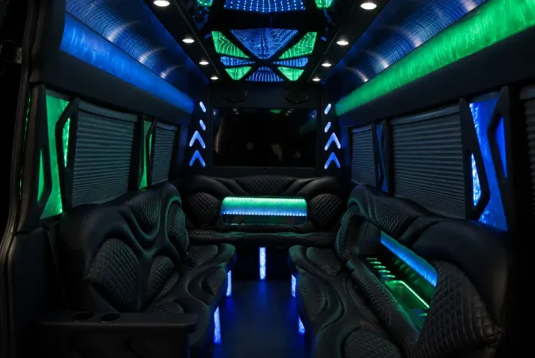 Mercedes-Benz Sprinter Limousine interior with perimeter lounge seating, window shades and LED accent lighting for party bus rental
