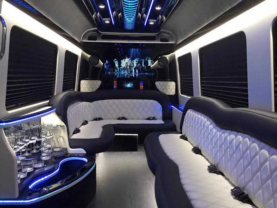Mercedes-Benz Sprinter Limousine interior with perimeter lounge seating, sofa-style seating and window shades for party bus rental