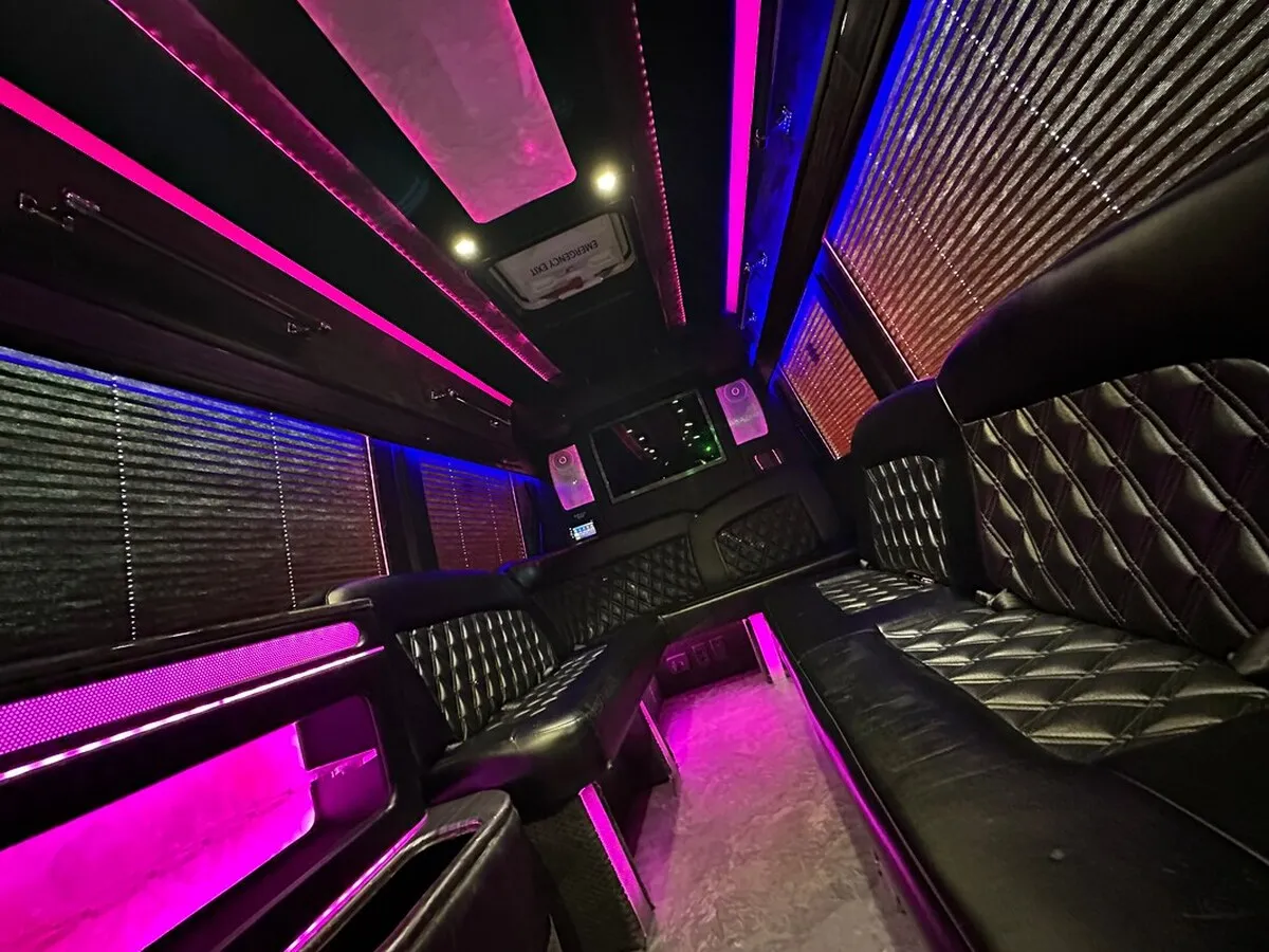Mercedes-Benz Sprinter XL interior with perimeter lounge seating, window shades and LED accent lighting, photo 3 for party bus rental