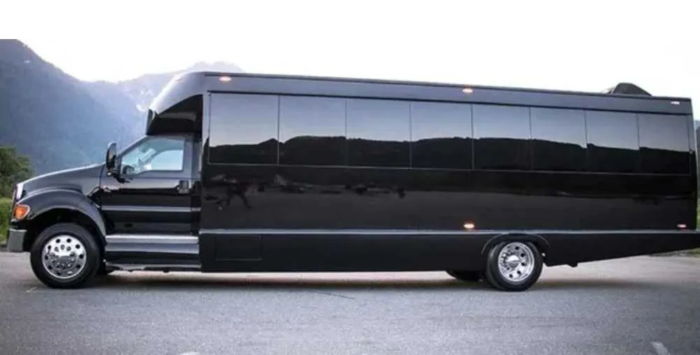 Black 30 Passenger Party Bus exterior with tinted windows for party bus rental