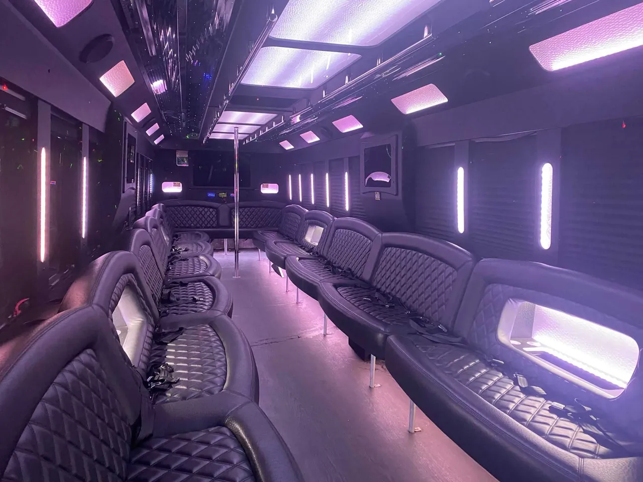 25 Passenger Party Bus interior with perimeter lounge seating, LED accent lighting and LED ceiling lighting for party bus rental in Ozone Park, NY 25 Passenger Party Bus interior with perimeter lounge seating, LED accent lighting and LED ceiling lighting for party bus rental in Ozone Park, NY