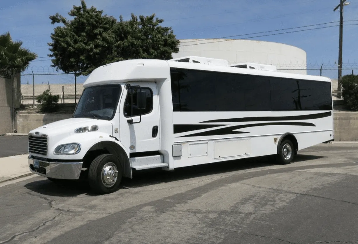 White 26 Passenger Party Bus exterior with tinted windows for party bus rental in Long Barn, CA
