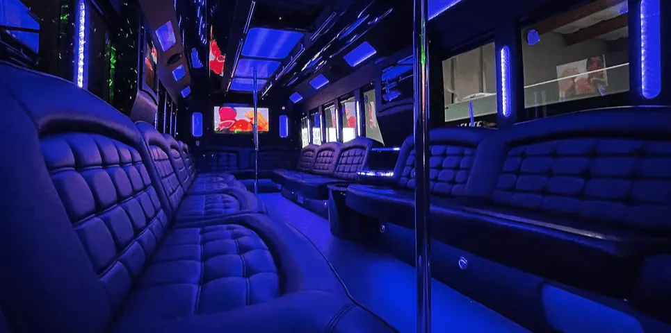 26 Passenger Party Bus interior with perimeter lounge seating, LED accent lighting and LED ceiling lighting for party bus rental in Rodeo, CA